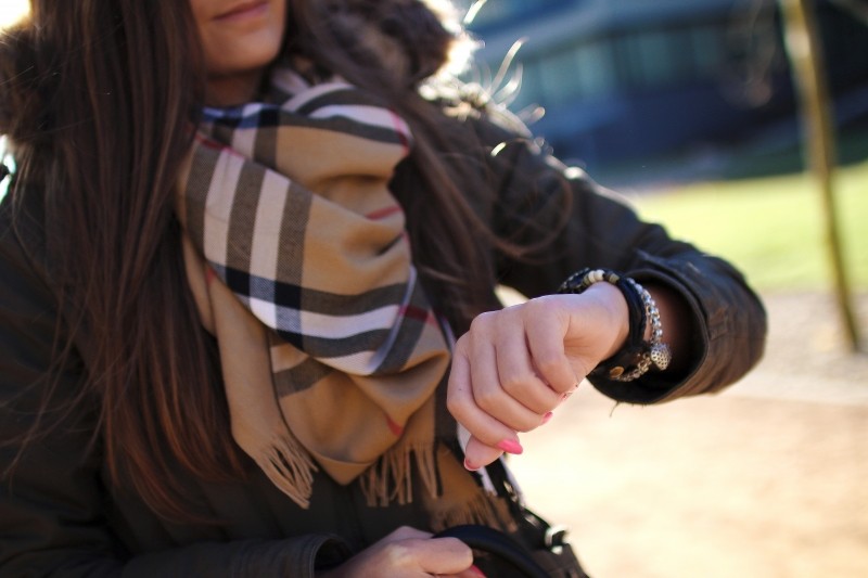 young-woman-checking-time-in-park