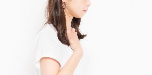 喉を触る女性